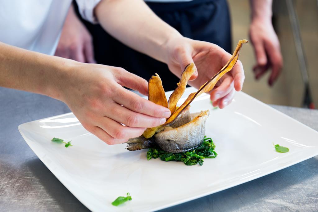 Troia Design Hotel Экстерьер фото A chef plating a dish